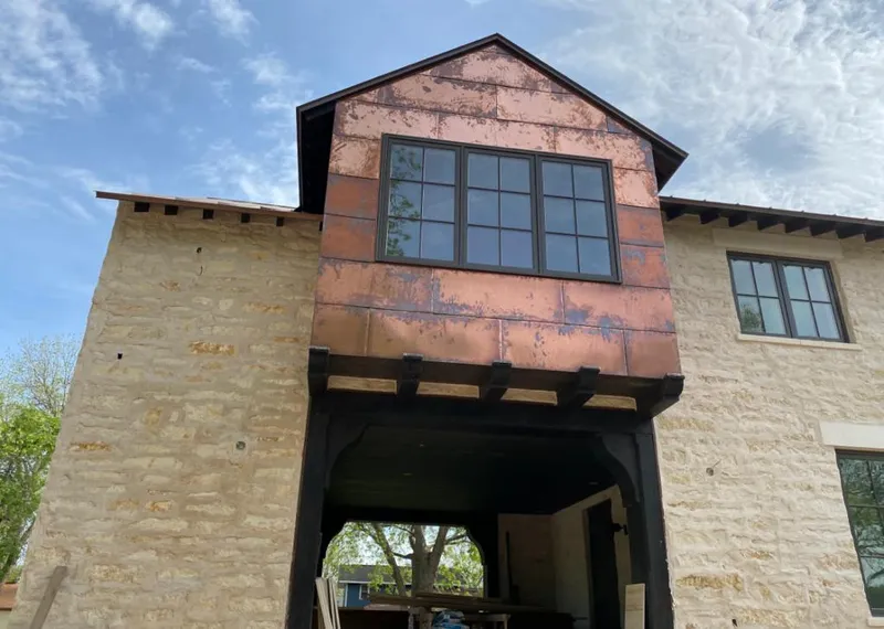 Copper metal panel facade on a stone building for Metal Roof Coating in Gladewater